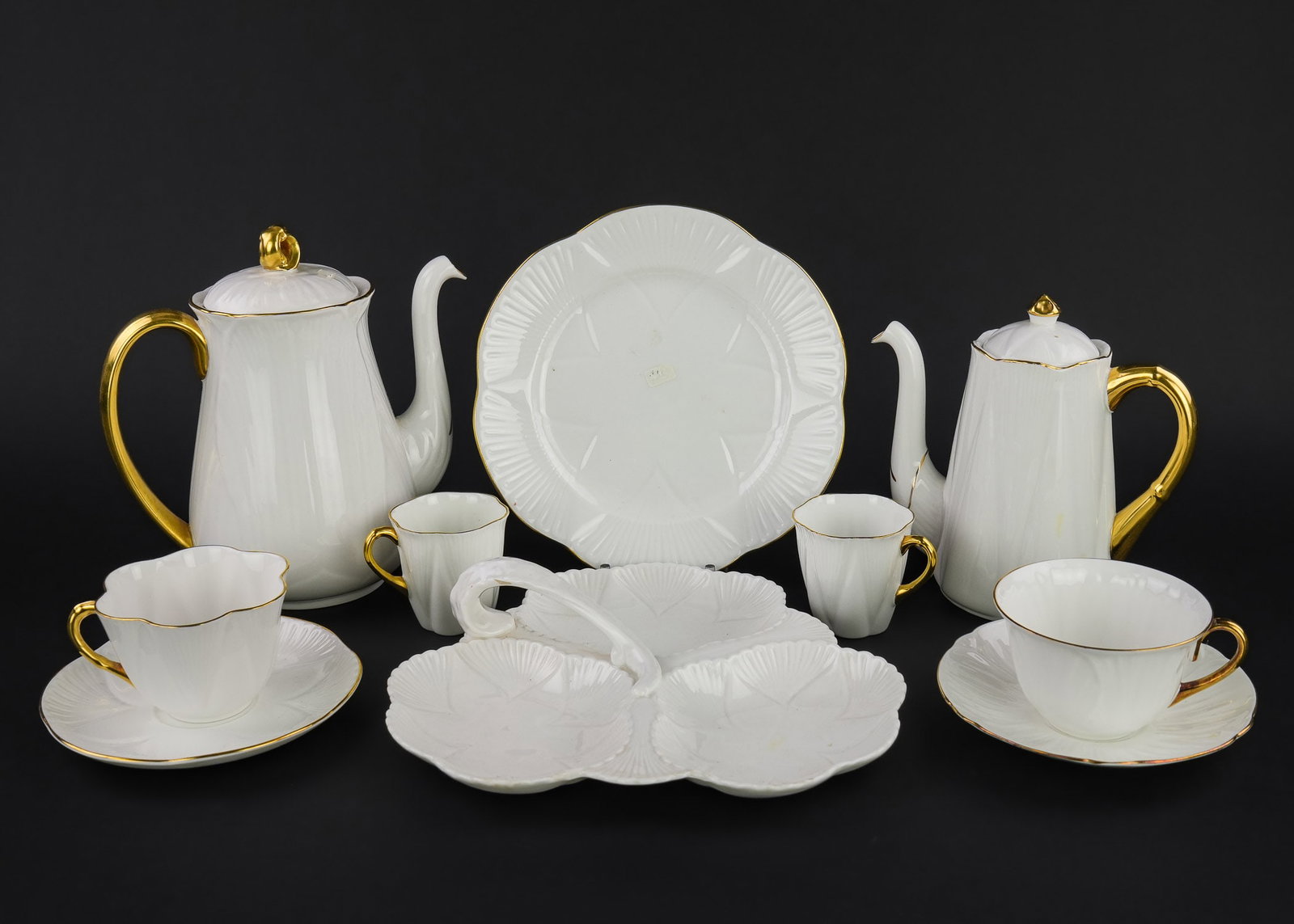 43 pcs. Shelley White Bone China Tea Ware: Collection of 43 pcs. Shelley fine English bone china porcelain gold rim white tableware including divided serving dishes, teapot and cocoa pot, cups and saucers, dessert plates, egg cup and serving p
