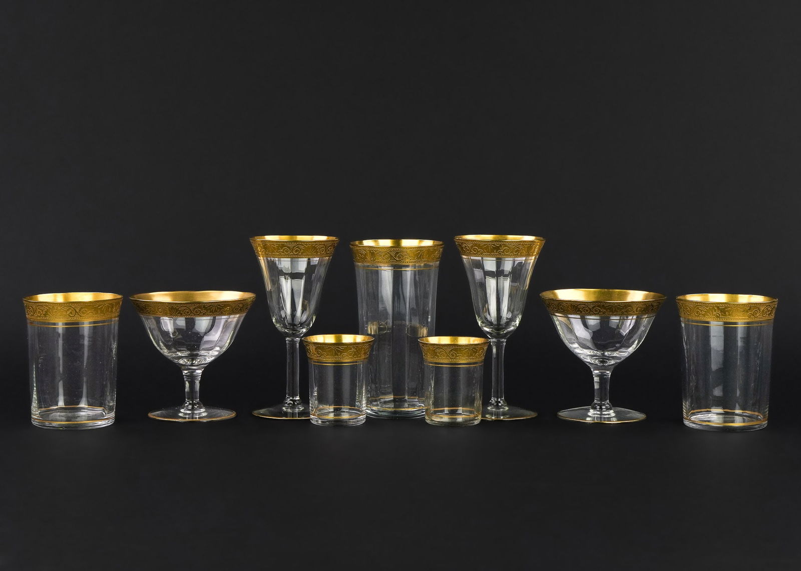 58 pcs. ca. 1920 Gold Band Engraved Stemware: 58 pcs. ca. 1920 gilt rimmed engraved stemware including 12 cordials, 11 small tumblers, 12 tumblers, 11 wine goblets, 12 sherbets, very good overall condition 2.5"-5.25"