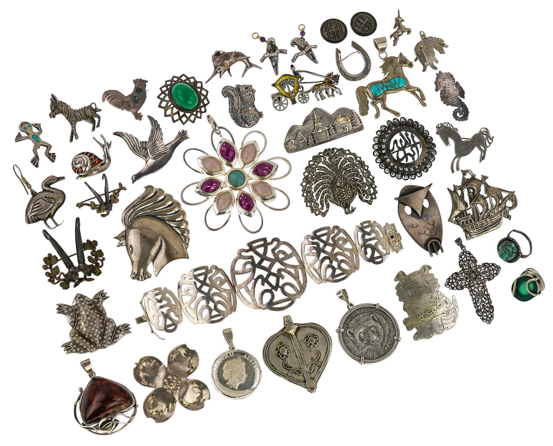 Vintage, Figural, & Sterling Jewelry: A group of Vintage, figural, and sterling jewelry including Turkey, owl, ship, horse head, snail, pendants, and more.
