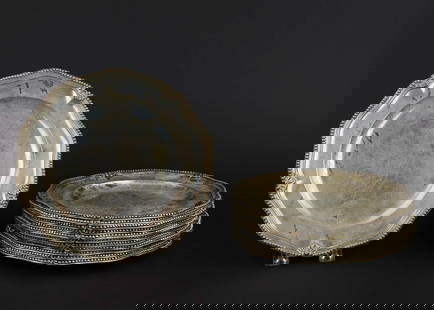 Twelve 1763 London Sterling Dinner Plates: Outstanding set of twelve 1764-65 William Grundy London Georgian style handwrought scalloped dinner plates having beaded and shell motif rim, old inventory numbers engraved on reverse, some knife scra