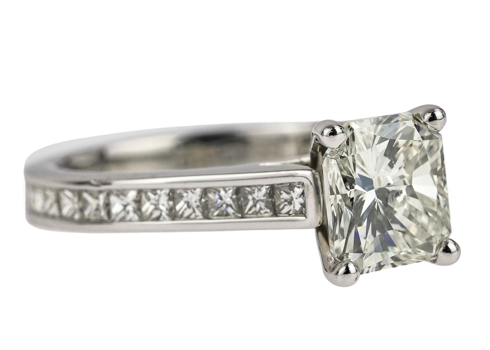 2.7 CT Diamond Platinum Engagement Ring: Platinum engagement ring set with a center 1.65 CT radiant cut diamond SI 1 G. With two sides set with 12 channel set square cut diamonds .06 cts each or approx 1.45 cts. 2.7 CT t.w. diamonds. Ring si