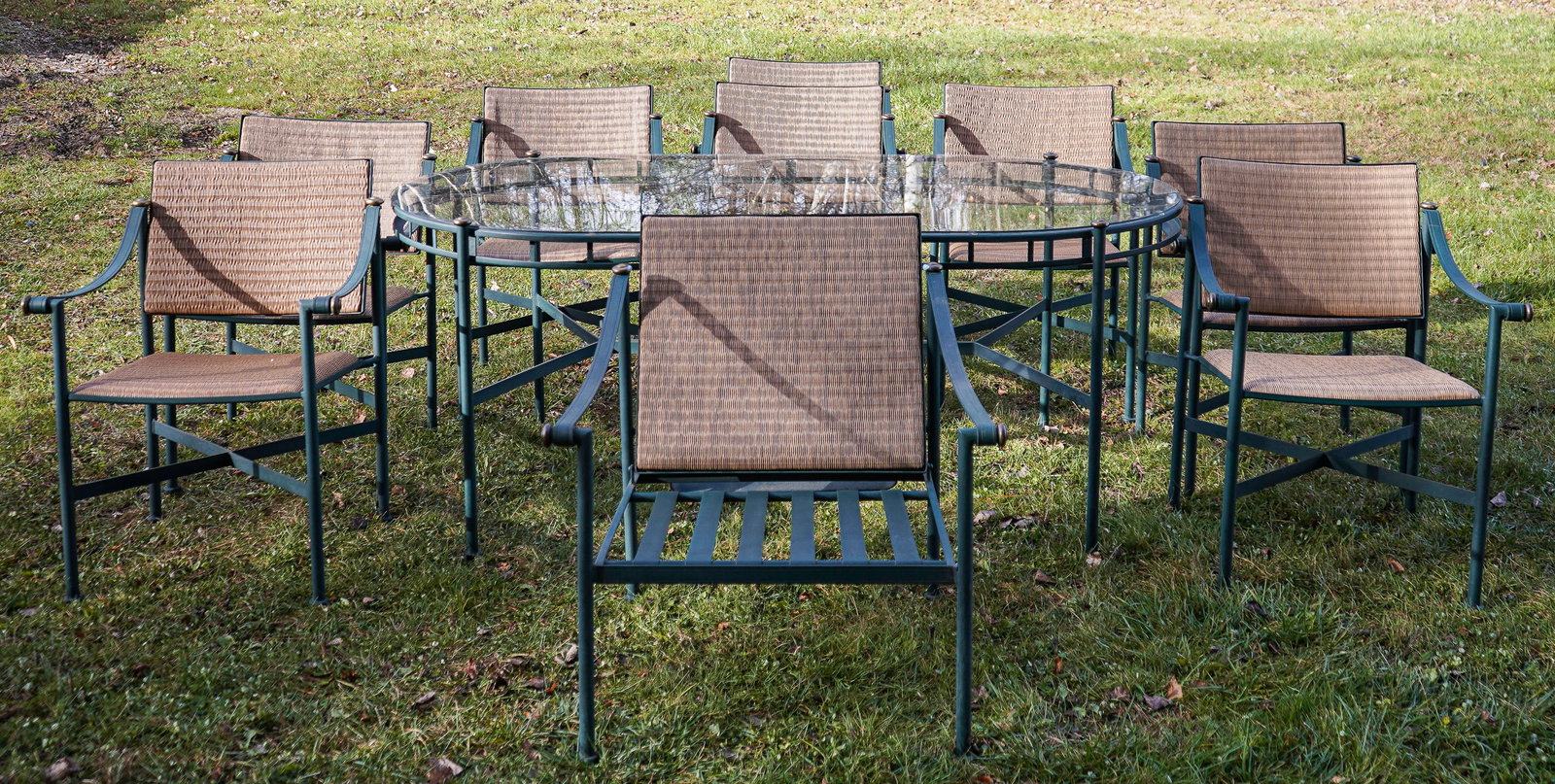Expansive Woodard Casablanca Outdoor Dining Set: 11 Piece Woodard Casablanca outdoor dining set in patinated verdigris finish, 8 armed dining chairs, 74 x 42 x 30" glasstop dining table, morris type lounge chair with ottoman.