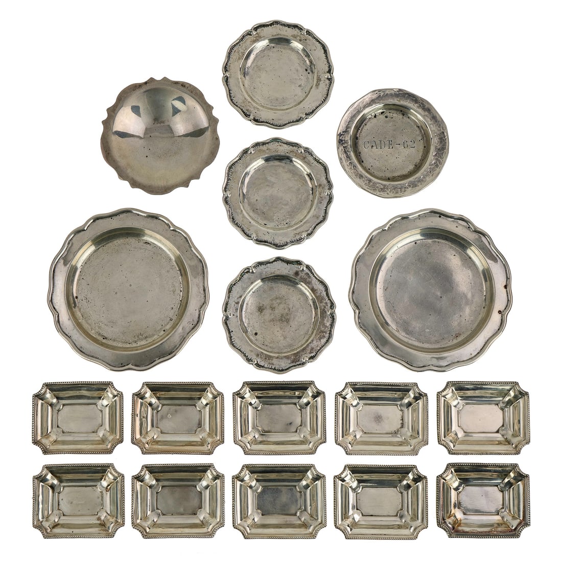 18 Small Sterling and 900 Silver Dishes: Group of 18 small sterling and 900 silver dishes including pair of Candella Chilean bottle coasters, 3 handwrought .925 butter pats, handwrought dish inscribed "CADE-62," Chilean tri-footed dish, and