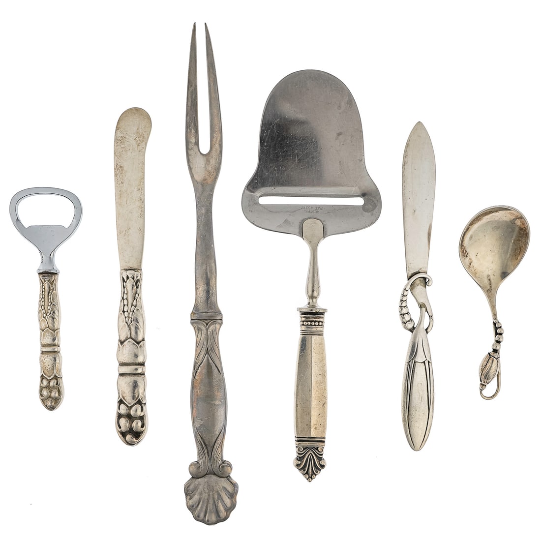 6 pcs. Georg Jensen Sterling Serving Flatware: 6 pcs. of assorted Georg Jensen Denmark sterling silver flatware including an unusual meat fork, two butter spreaders (one faintly marked), an Acanthus pattern cheese slice with stainless blade, a bot