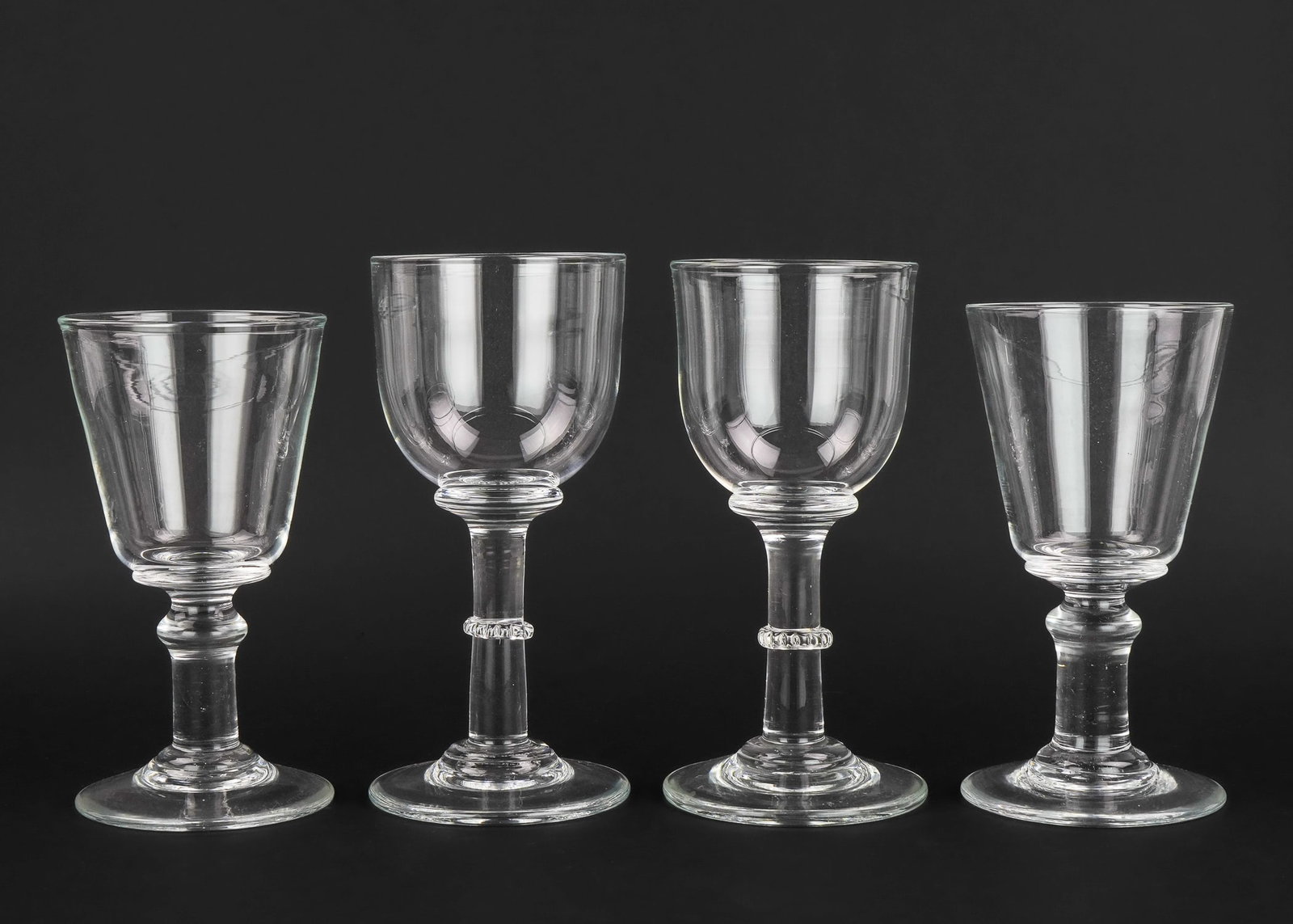 4 Simon Pearce Blown VT Art Glass Goblets: Group of 4 Simon Pearce Quechee, Vermont artisan blown oversized goblets, with characteristic 4 leaf pontil marks, one signed, ht. 9"-10"