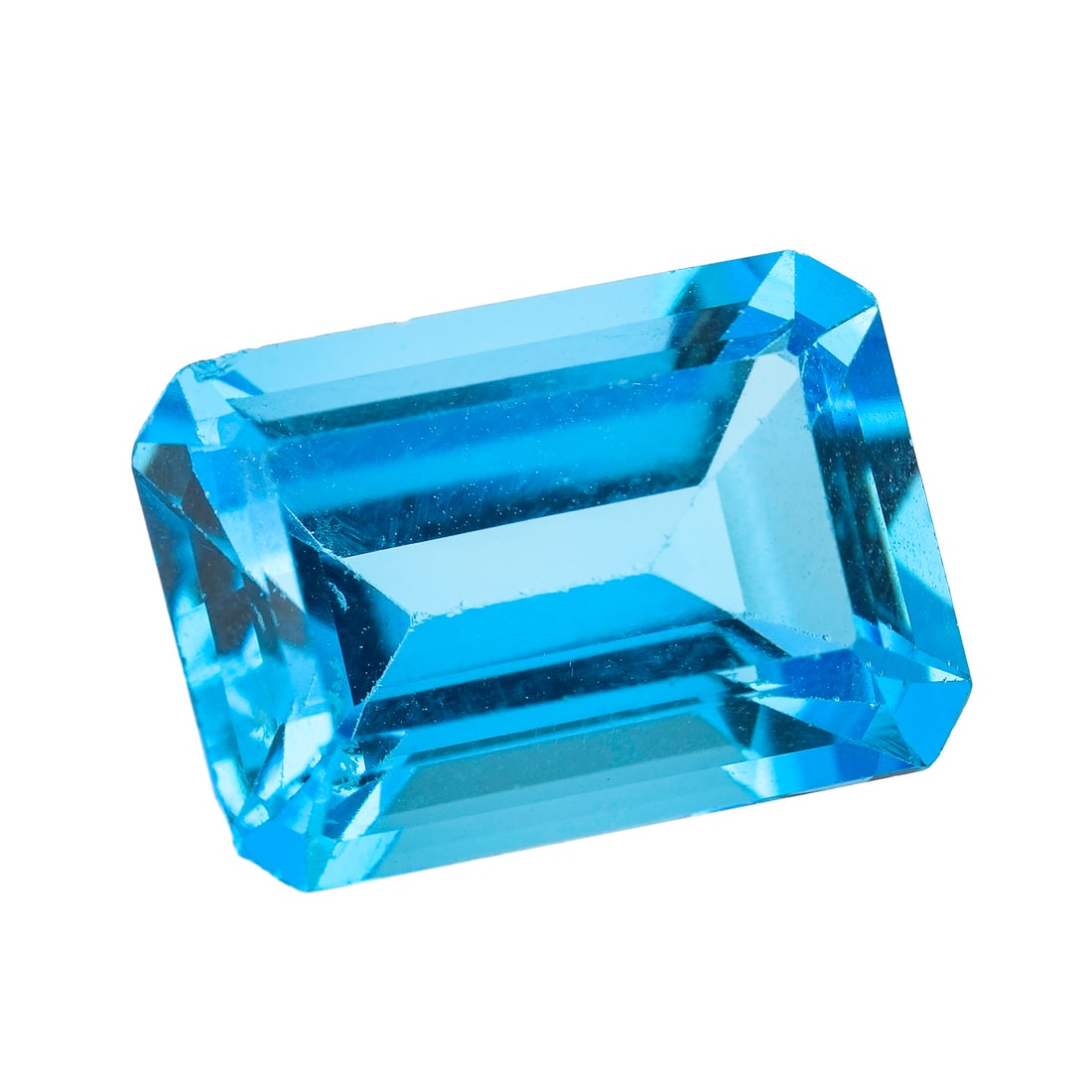 Emerald Cut Blue Topaz: Deep blue emerald cut blue topaz. 14 mm x 10 mm x 7 mm