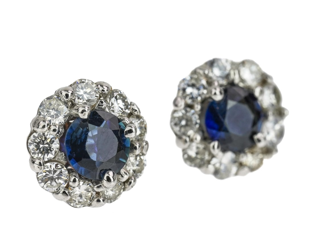 Diamond & Sapphire Stud Earrings: Diamond and sapphire 14k white gold stud earrings with center round cut 1/2 ct sapphire. In each with 9 round cut .06 ct diamonds. 1 ct t.w. sapphires, 1.1 ct t.w. diamonds.