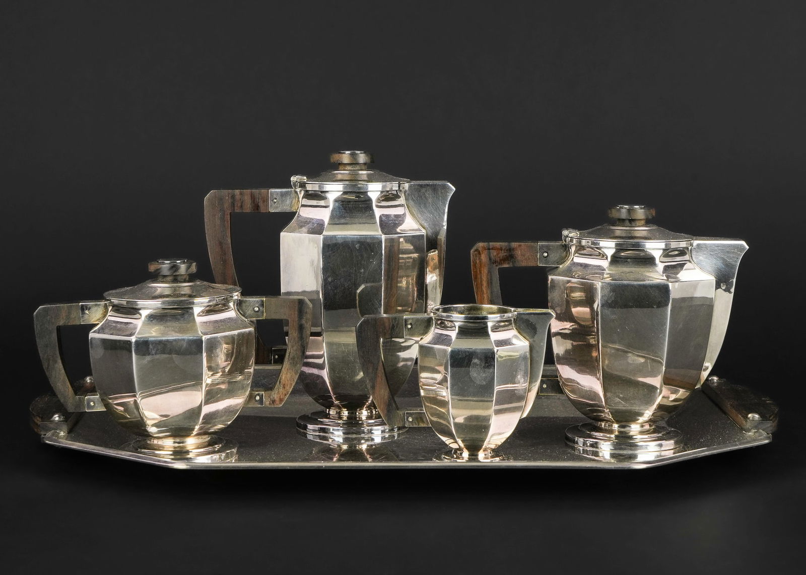 Gallia Christofle Art Deco Silverplated Tea Set: ca. 1930 Gallia Christofle Art Deco silver plated tea service including coffee pot, teapot, covered sugar bowl and creamer, all in an octagonal paneled form with matching tray with rosewood handles an