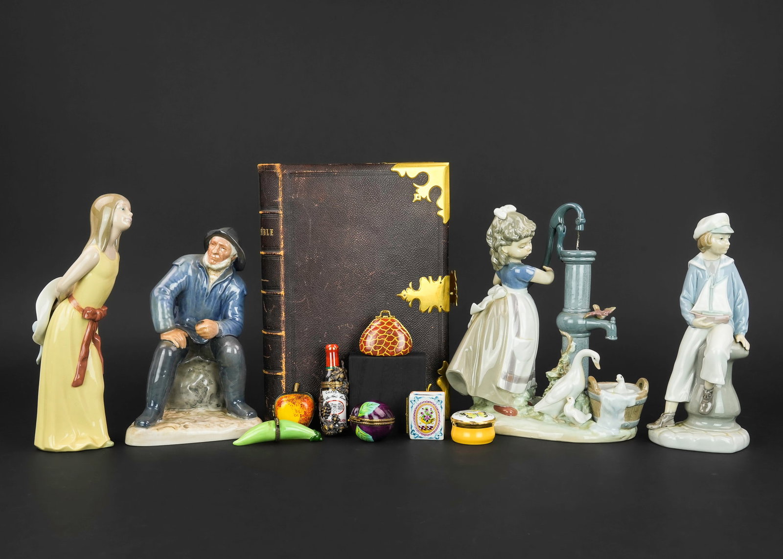 Lladro Figurines, Limoges Pill Boxes, Early Bible: Lot of decorative accessories including 3 Lladro Spanish porcelain, Bing and Grondahl fisherman figurine, 7 pillboxes including Rochard Limoges, Colonial Williamsburg, accompanied by an 1850 leatherbo