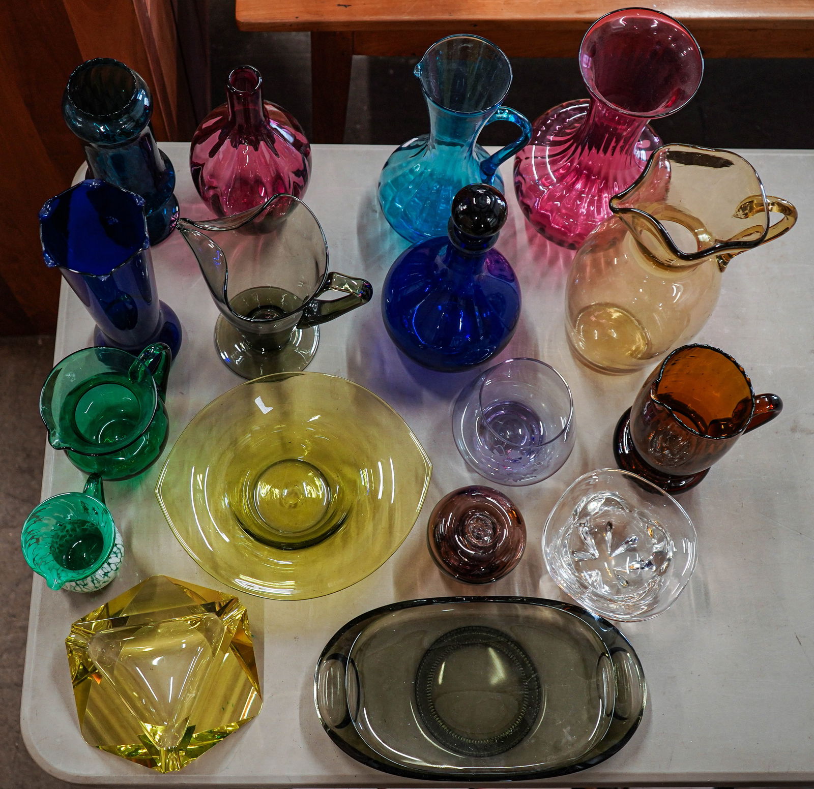 Group of Mid Century Colored Art Glassware: Group of mid century colored art glassware including cobalt decanter, cranberry glass vases, uranium glass ashtray, Emerald, amber, olive and colorless pieces, etc.