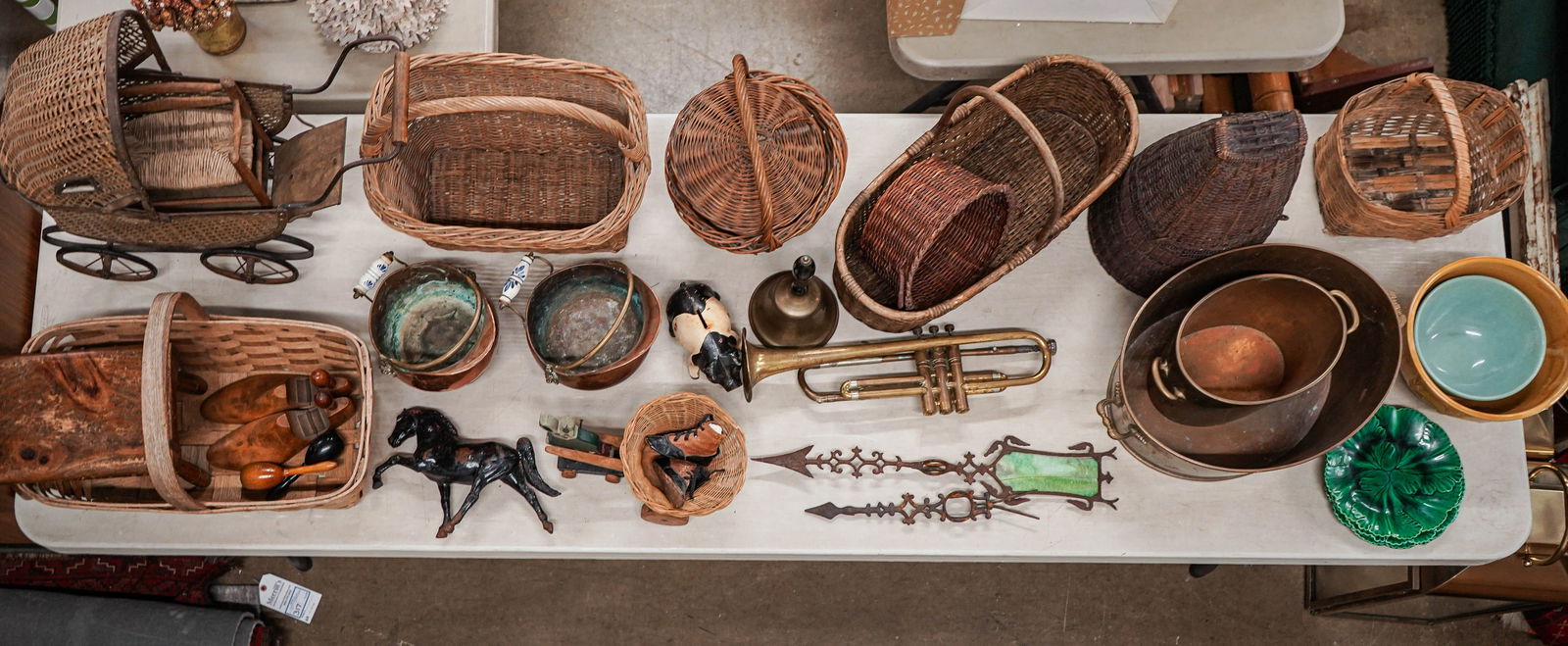 Large Estate Lot of Country Accessories: Large estate lot of country accessories including ash splint and other baskets, 1920s wicker doll perambulator, small wooden cricket footstool, 2 copper coal scuttles, cast iron pig bank, iron horse f