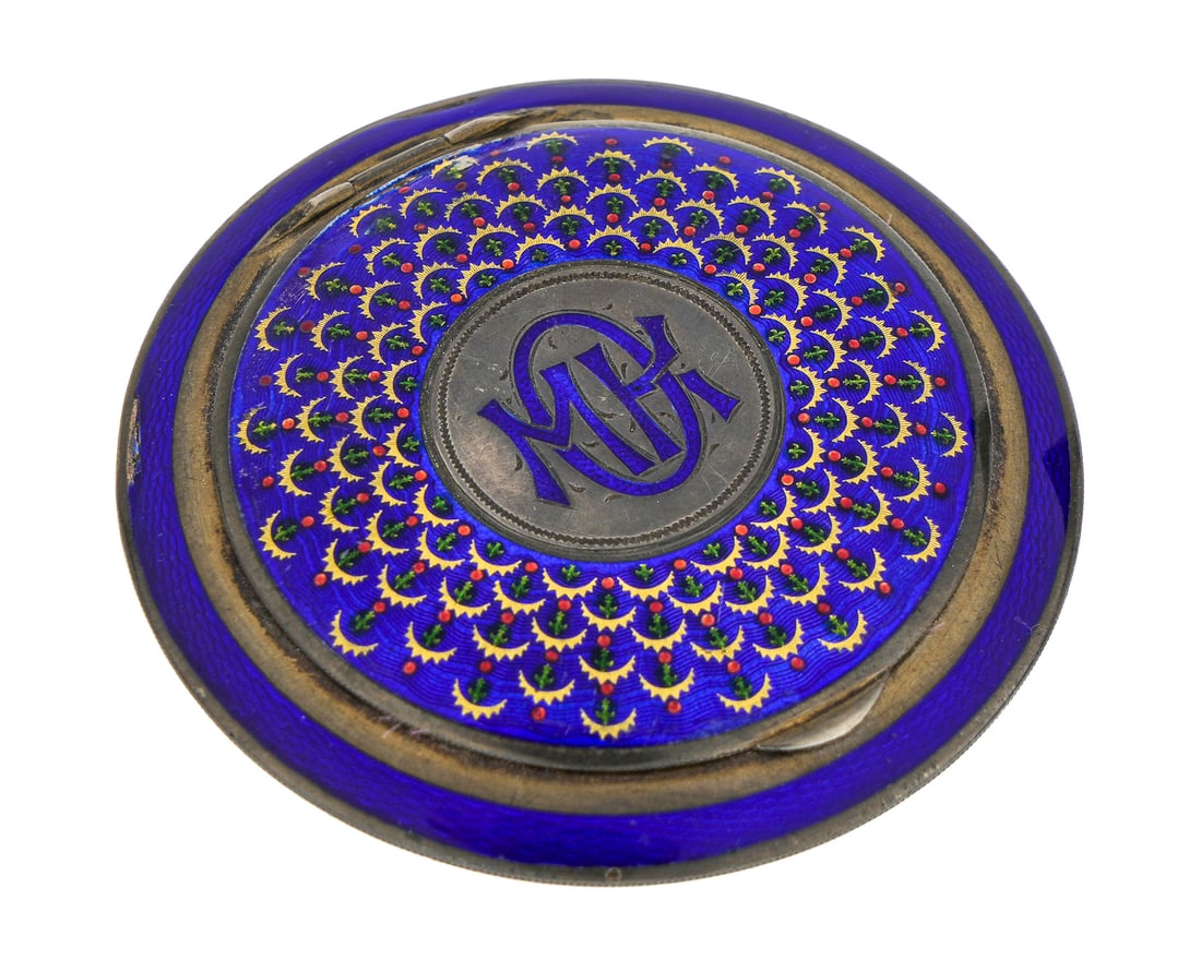 Austrian Sterling & Enamel Compact: Round ca. 1900 Sterling enamel Austrian compact. Green, red, gold, & blue enamel. Monogrammed M O K. Mirror interior with puff. 3 1/8" diameter. 2 edge damage to enamel.