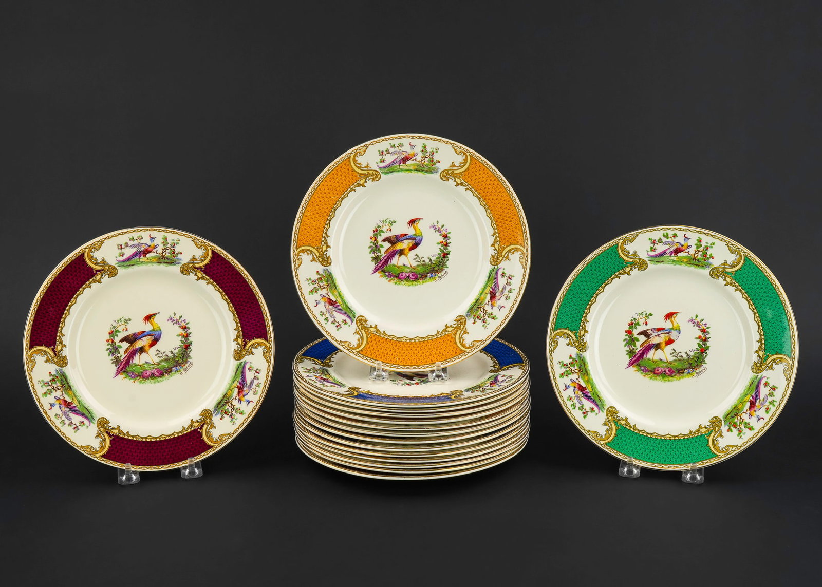 16 Myott Chelsea Bird Harlequin Luncheon Plates: Set of 16 Myott Chelsea bird transfer decorated luncheon plates having raised gilt accents and multi-colored harlequin blue, green, maroon and gold dia. 9" -some crazing, one has rim check