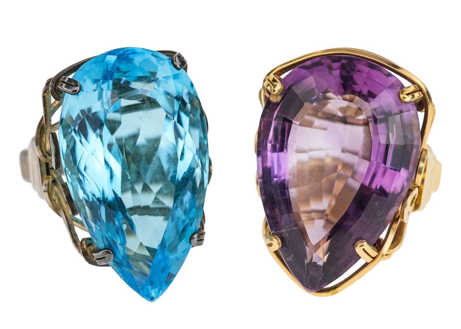 Pair of Large Teardrop Amethyst & Blue Topaz Rings: Two rings, a large 28 mm x 20 mm teardrop cut amethyst in yellow wire ring frame with a 30 mm x 18 mm teardrop cut blue topaz in a silver wire frame. Ring size 6.5.