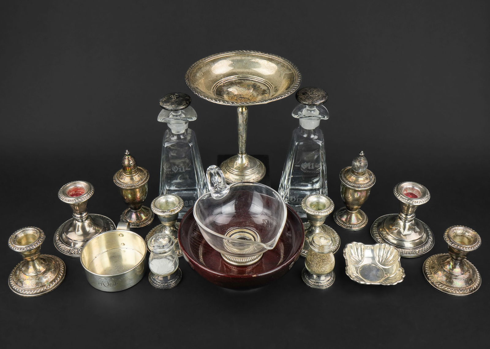 17 pcs. Assorted Sterling Silver Hollowware: 17 pcs. of assorted sterling silver hollowware including 6 gadrooned weighted candlesticks, 2 pair of weighted sterling salt and pepper shakers, 2 salad dressing bottles with sterling stoppers, sterli