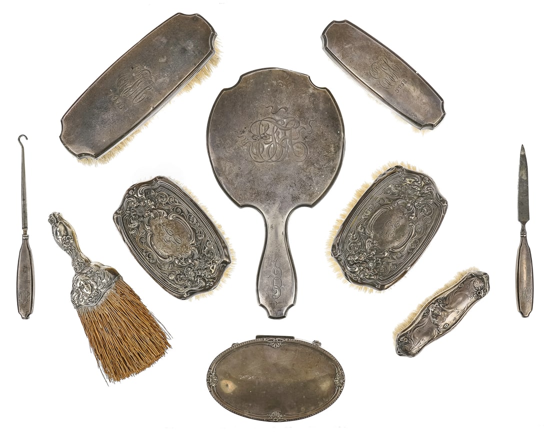 10 Sterling Silver Ladies Dresser Items: Group of 10 sterling silver dresser vanity items including 5 pc. dresser set, pair of poppy decorated repousse brushes, Birmingham sterling footed oval dresser box, and Art Nouveau female figural repo