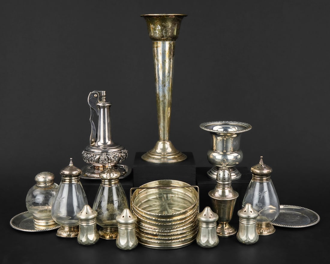 22 pcs. Sterling Silver Hollowware: 22 pcs. assorted sterling silver hollowware including trumpet bud vase, small weighted urn, 2 coasters, 8 sterling banded cut glass coasters in sterling frame, 9 salt and pepper shakers, accompanied b