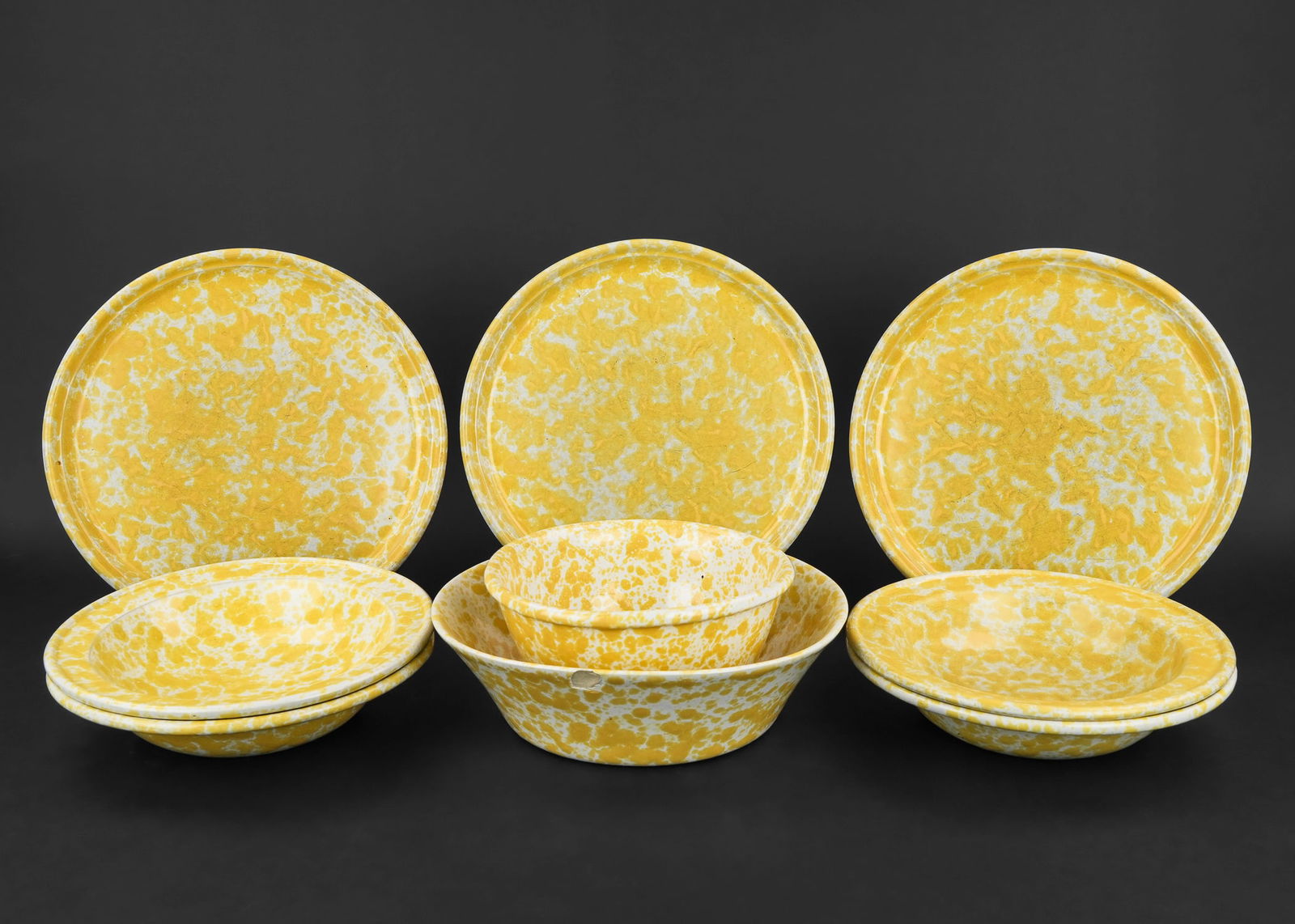 8 pcs. Bennington Yellow Agate Pottery: 8 pcs. Contemporary Bennington Potters "Morning Glory" yellow agate glaze tableware including 3 dinner plates, 4 soup bowls, mixing bowl, and serving bowl (having rim chips). Some knife wear, otherwis