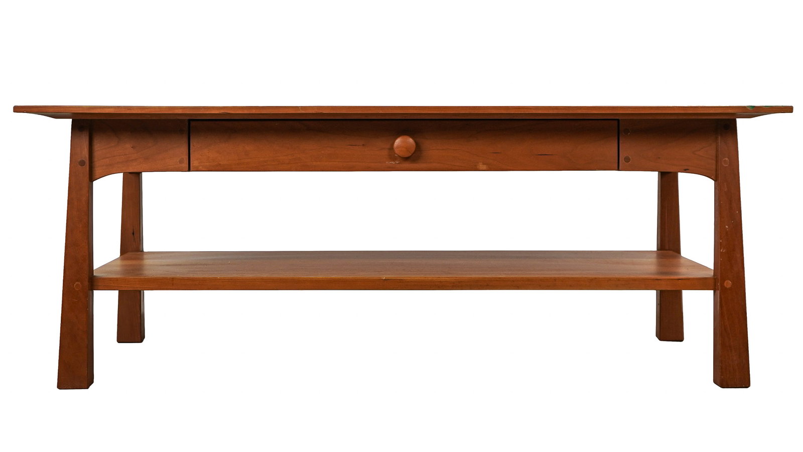 Pompanoosuc Mills Cherry Coffee Table: Pompanoosuc Mills Vermont contemporary Arts & Crafts style cherry coffee table. Chamfered top, single drawer, lower shelf on elephant form legs. Good condition. 22"w, 42"l,16"h.