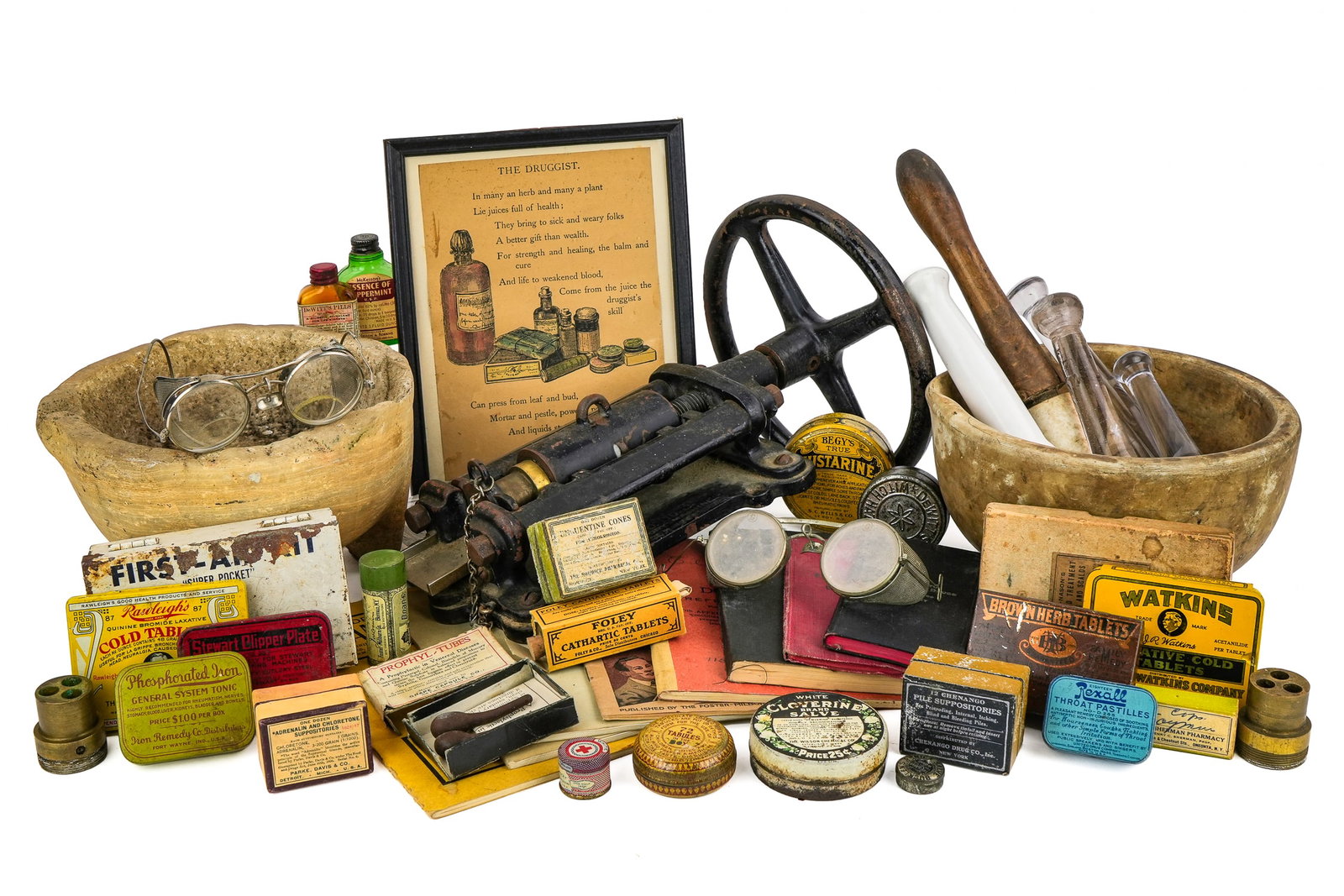 Antique Pharmaceutical Implements and Accessories: Group of antique medical and pharmaceutical implements including stone mortar, cast iron and brass pill press, assorted glass and wood pestles, advertising paperweight showing the plant of Boehringer