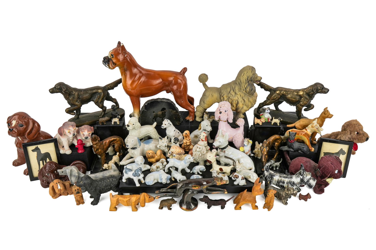 Collection of Vintage Dog Figurines: Collection of vintage assorted dog figurines including carved wood, porcelain, stone, cast metal, composition, patinated cast iron and spelter bookends, etc., .5"-8.5"