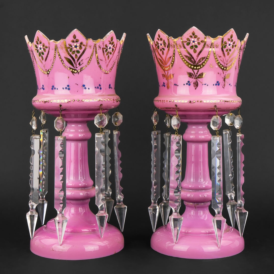 Pair of Pink Bohemian Glass Mantle Lusters: Pair of 19th c. Victorian pink cased Bohemian glass mantle lusters with cut glass prisms and gilt decoration, some wear to gilding, old check to one rim 13" x 6"