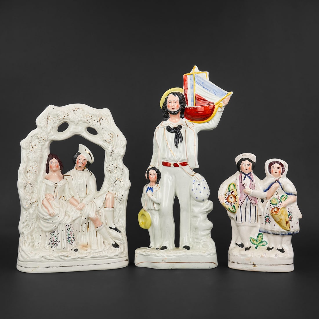 3 19th c. Staffordshire Pottery Mantel Figures: 3 mid 19th c. English Staffordshire pottery mantel figures including romantic courting couple, flower sellers, and boy with father holding a pond boat 9.5", 14", 17"