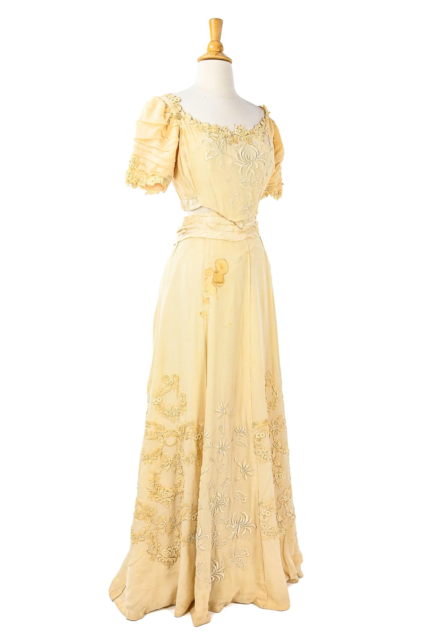 Victorian Ecru Outfit: A Victorian outfit made up of a bodice and skirt. Bodice is adorned with lace detailing, gathered puff sleeves, tonal embroidery down the center and boning at the sides. Measures 15" across shoulders