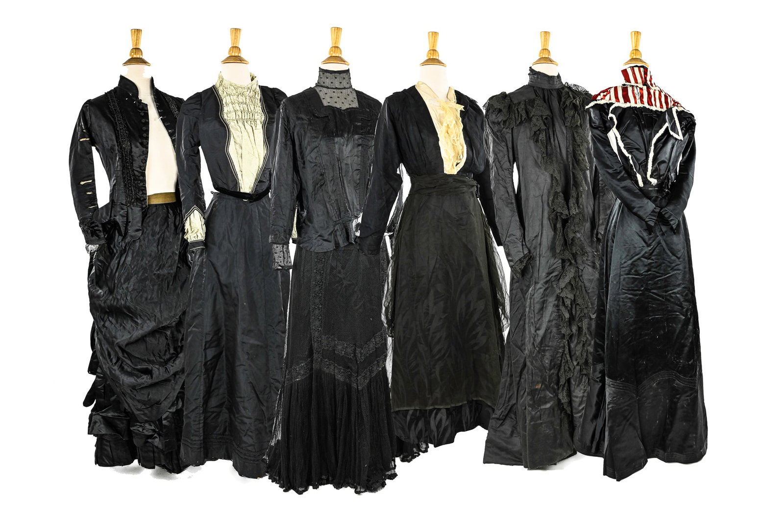 6 Black Victorian Outfits: Six unique black Victorian outfits made up of blouses and skirts, a dress and one linen apron. Good condition.
