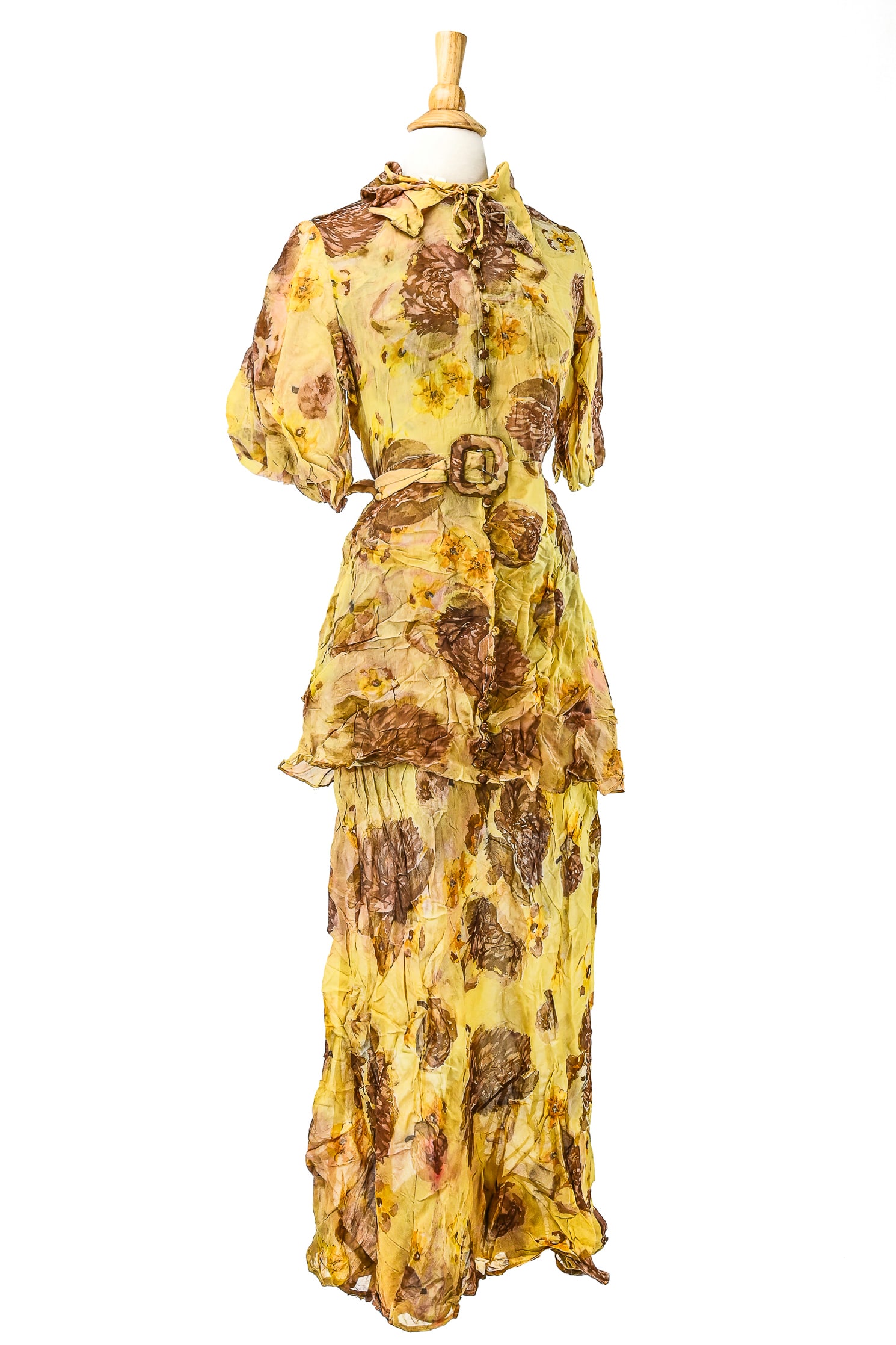 Ca. 1930's Floral Printed Day Dress: Ca. 1930's Georgette crepe floral day dress. Sheer gold ground with printed florals in brown and yellow. Puff sleeves, ruffled collar, attached belt and ornamental buttons down center. 18" across shou