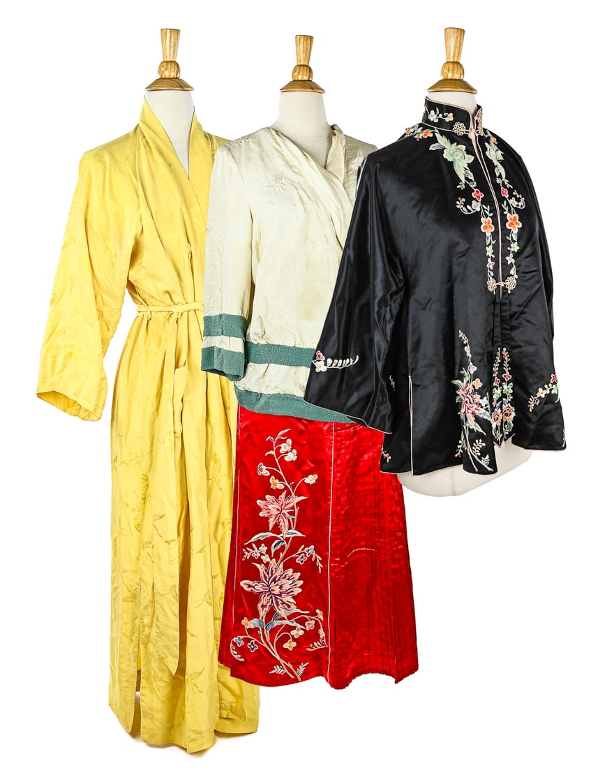 Lot of Four Asian Silk Garments: Lot of four Asian-inspired silk garments. Includes a black silk coolie coat with mandarin collar, measuring approximately 14" across the shoulders and 28" long; a red silk skirt with a 28" waist circu