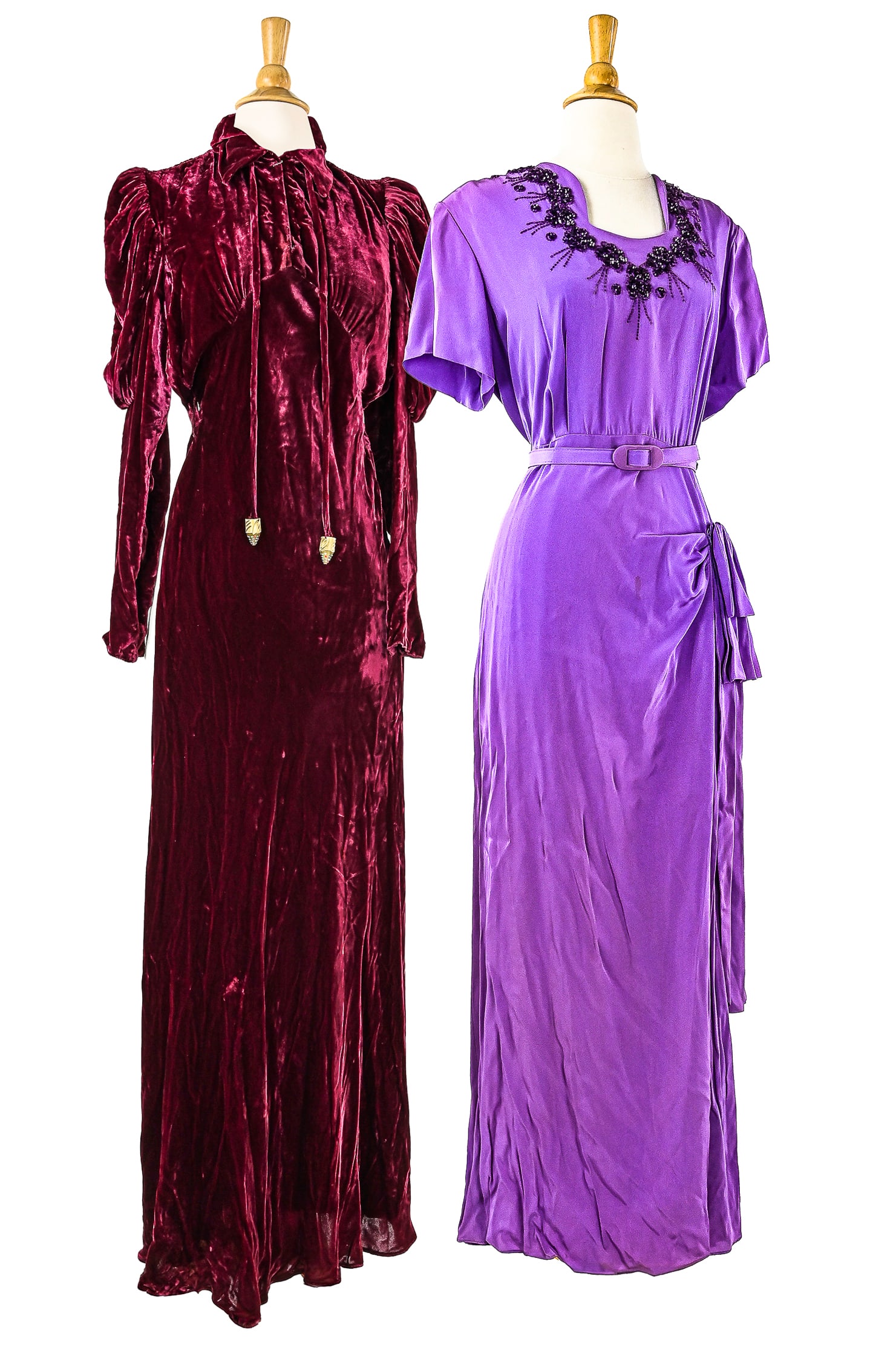 2 Early 20th c Evening Dresses: Two early 20th c evening dresses. One dress is a dark wine colored velvet with a gathered empire waist and ties with jeweled points. Measuring 59" long. One dress purple with floral beading along neck