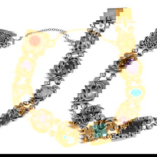 14k Vintage Charm Bracelet: Unusual 14k yellow gold charm style bracelet having 10 panels connected by 2 beads. Each panel set with different stones and forms including a small creature with pearl head, red coral bead, 2 amethys