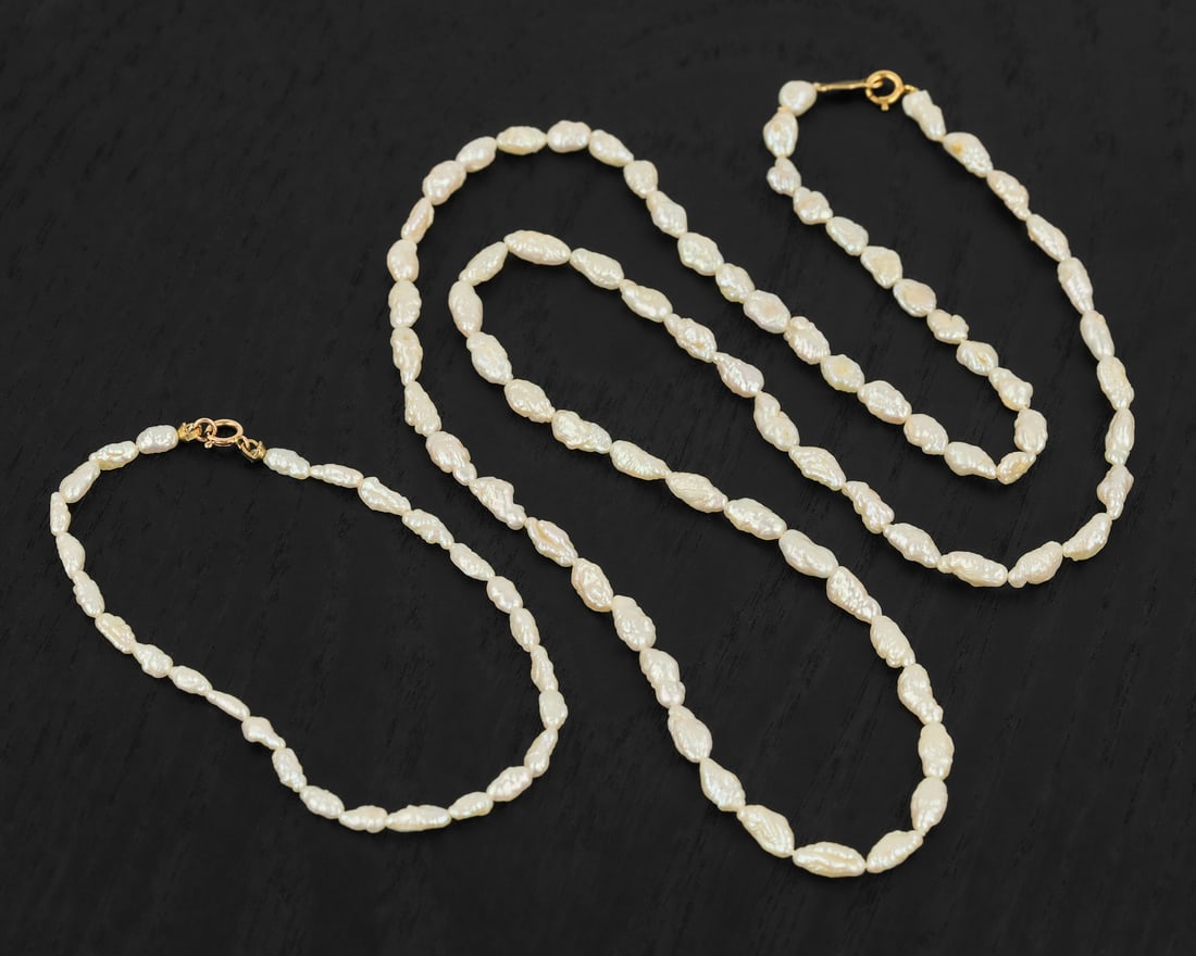Freshwater Pearl Necklace & Bracelet: Freshwater pearl necklace 24" long with a 6 1/2" long bracelet. Each with a 14k yellow gold clasp.