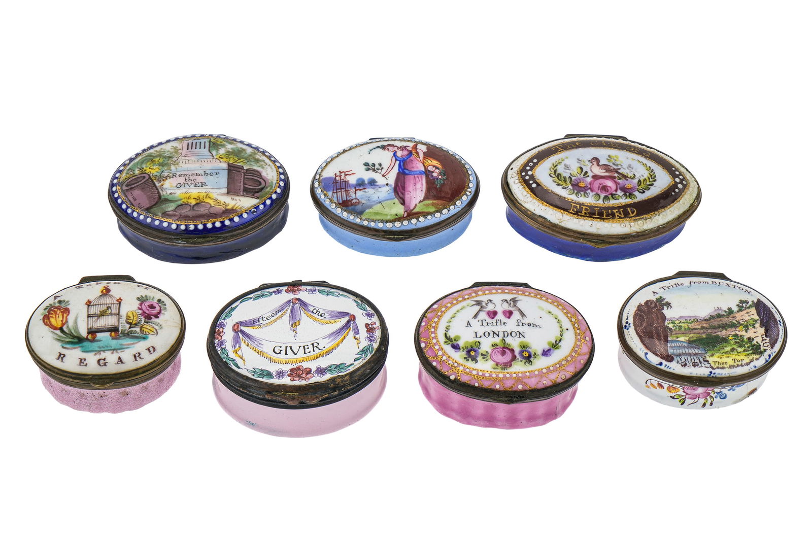 6 Oval Battersea Enamel Pill Boxes: Group of 6 early 19th c. Battersea enamel presentation oval pill boxes, some with scenic and floral decoration, inscribed with mottoes including "A Trifle from Buxton", "A Trifle from London", "Rememb