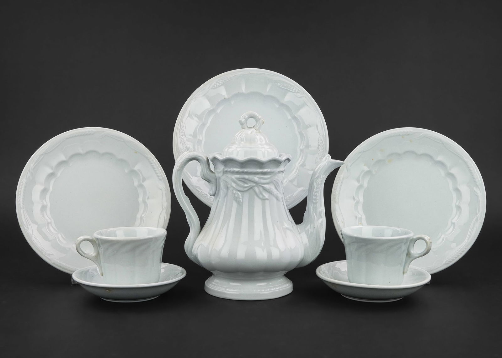 Collection of White Ironstone Tableware: Collection of 50 pcs. of 19th c. English White Ironstone dinnerware all in embossed wheat pattern including two covered serving dishes, covered sauce boat, 10 cups, child's tea set, etc., by various m