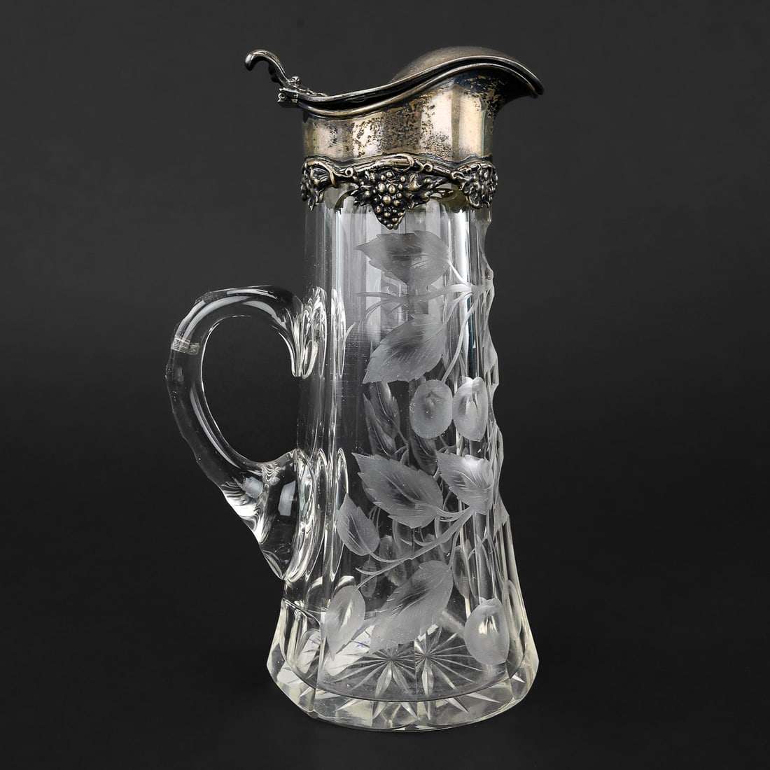 J.F. Fradley & Co. Cut Glass Pitcher with Sterling Lid: Late 19th century cut glass pitcher with finely detailed sterling silver hinged lid by J.F. Fradley & Co., New York. Elegant form with deep cutting in a cherry & leaf pattern, and quality silverwork. 