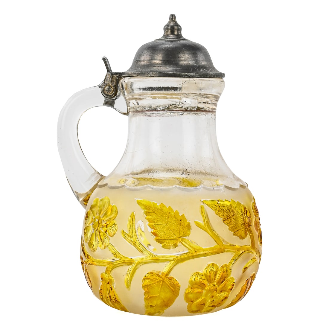 Amber Cut Glass Syrup/Creamer with Pewter Lid: Amber-colored cut glass syrup or creamer featuring an applied handle and a pewter lid. Decorated with a floral vine motif surrounded by etched frosted glass. Measures approximately 7" tall by 4" wide.