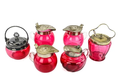 Six Cranberry Glass Pieces Including Sugar Jar, Pitchers, and Jam Jar