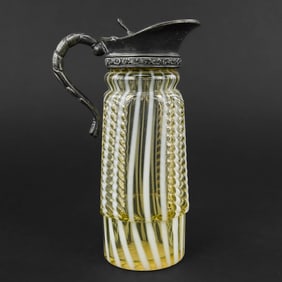 Small emerald green pressed glass pitcher, circa 1888, attributed to Heisey’s “Winged Scroll