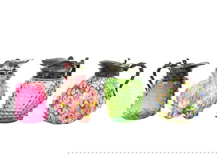 Four Art Glass Syrup Pitchers: Group of four art glass syrup pitchers, including a Fratelli Toso millefiori example with a loose lid, a cranberry glass pitcher with a diamond pattern, a Royal Ivy syrup pitcher, and an iridescent gr