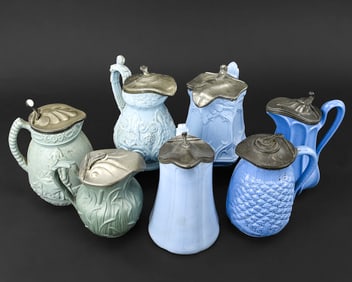Five milk white glass syrup pitchers cut to cranberry red, cobalt blue, and emerald green, each with