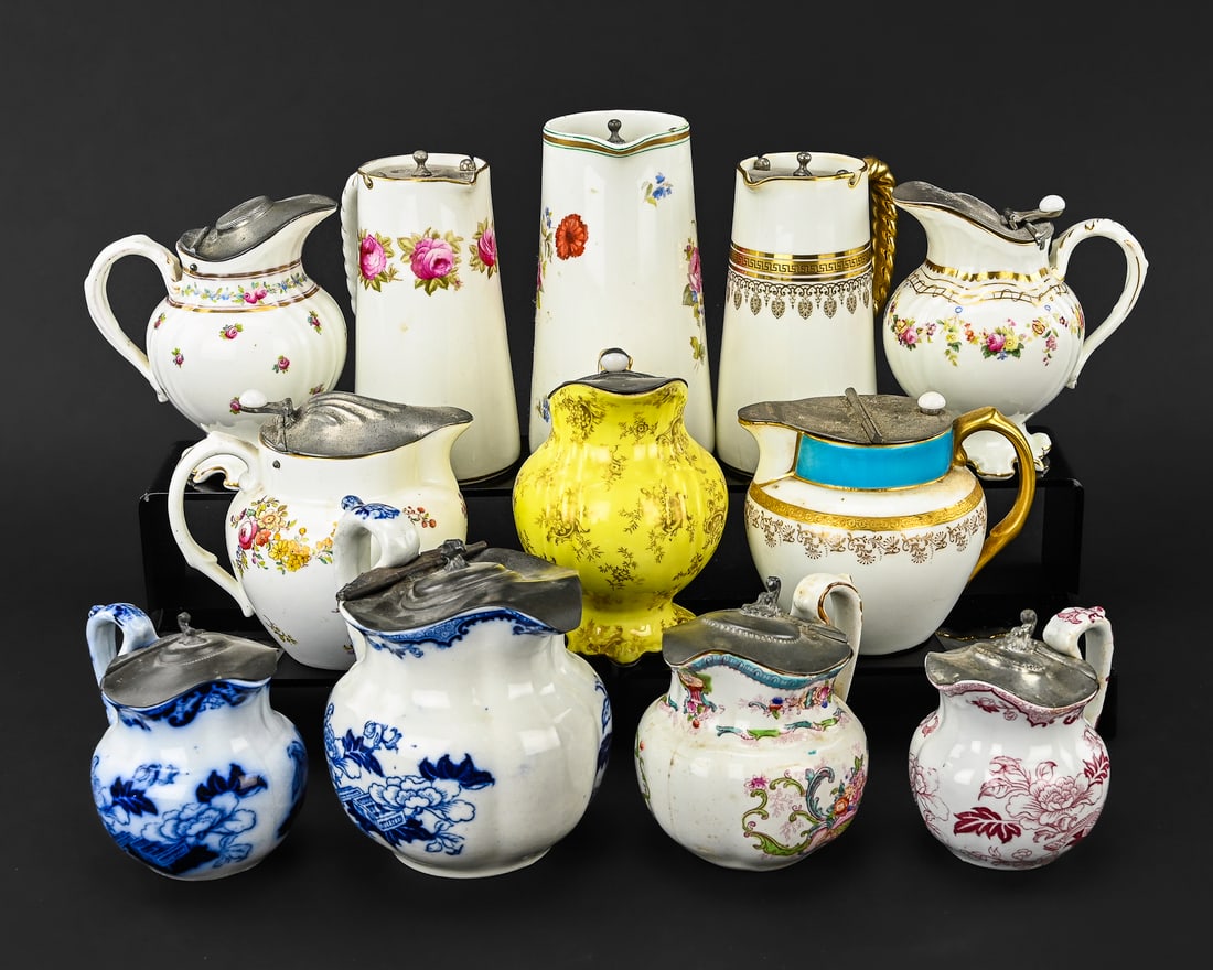Twelve Cauldon Floral and Gilt Decorated Ceramic Pieces with Retailer Stamps: A collection of twelve Cauldon ceramic pottery pieces featuring floral and gilt decoration. Most items are stamped by the maker, with some also bearing retailer marks from NYC, Boston, and London. The