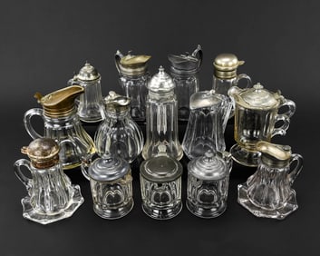 14 Pressed Glass Syrup Pitchers, 19th C.