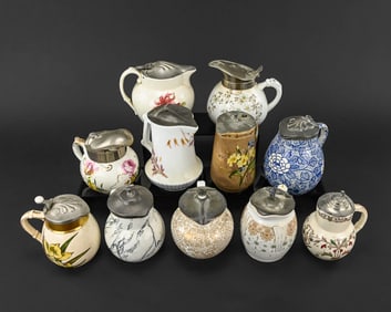 11 Decorated Stoneware Syrup Pitchers
