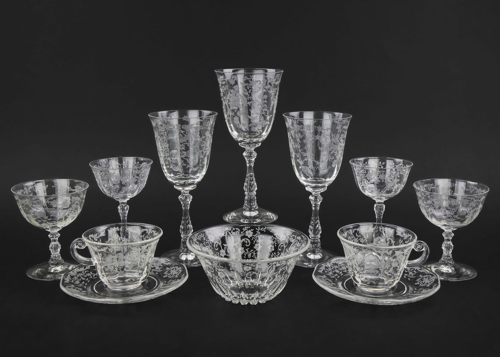 74 pcs. Fostoria Etched Crystal Tableware: 74 pcs. Fostoria Elegant Depression Era glass tableware having etched decorations in various patterns including wine glasses, dessert plates, cups and saucers, tazzas, serving dishes, goblets, sugar a