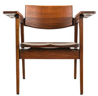 Gunlocke Walnut Armchair: Walnut mid-century modern arm chair with shaped back, saddle seat, and wide armrests. With partial tag from the Gunlocke Chair Co. Wayland, NY. 29 1/2" wide (outside arms) and 31" h.