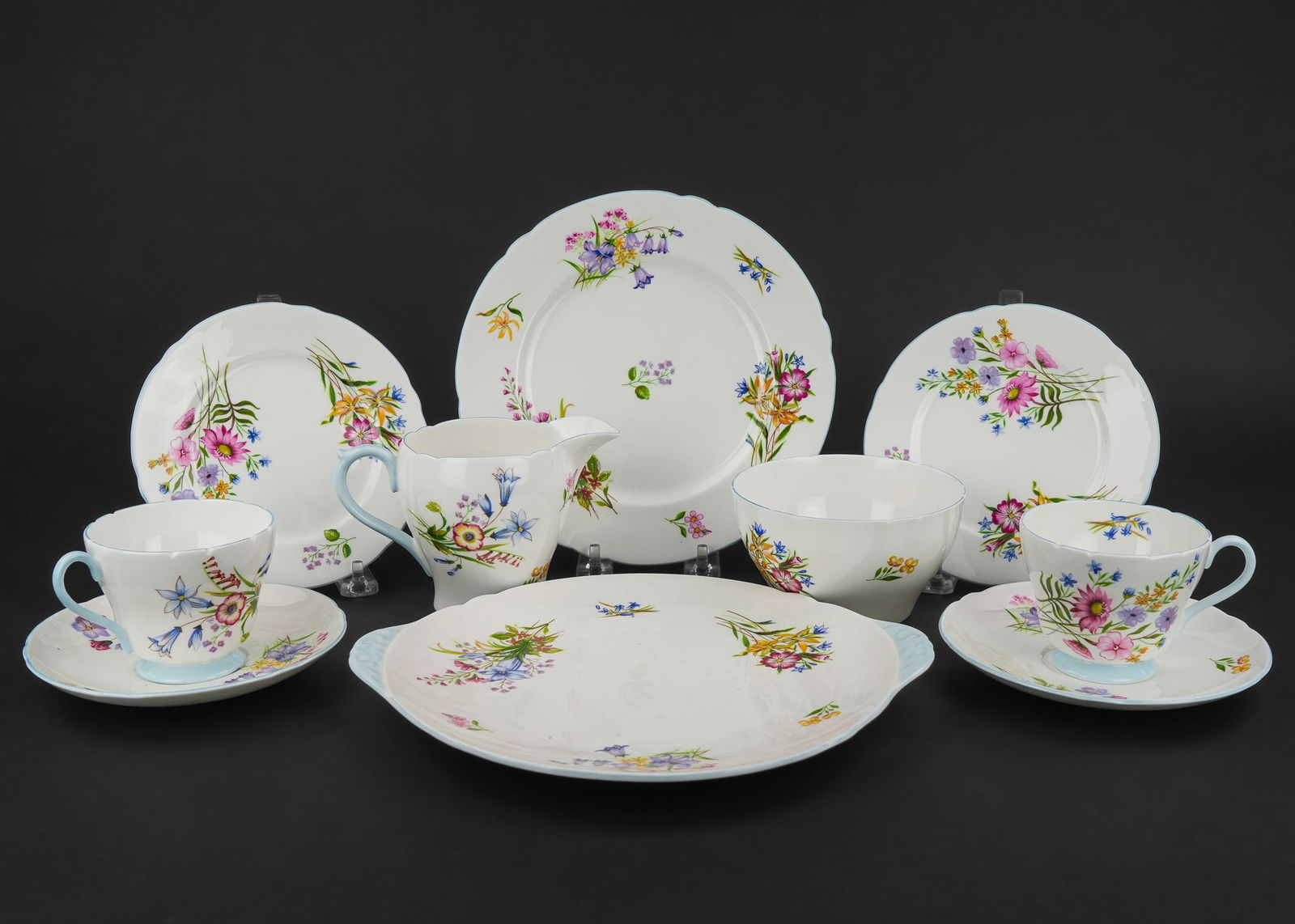27 pc. Shelley English Bone China Tea Set: 27 pc. Shelley English bone china porcelain tea set including 6 cups and saucers, sugar and creamer, 6 side plates, 6 luncheon plates, and double handled cake plate. Overall very good condition.