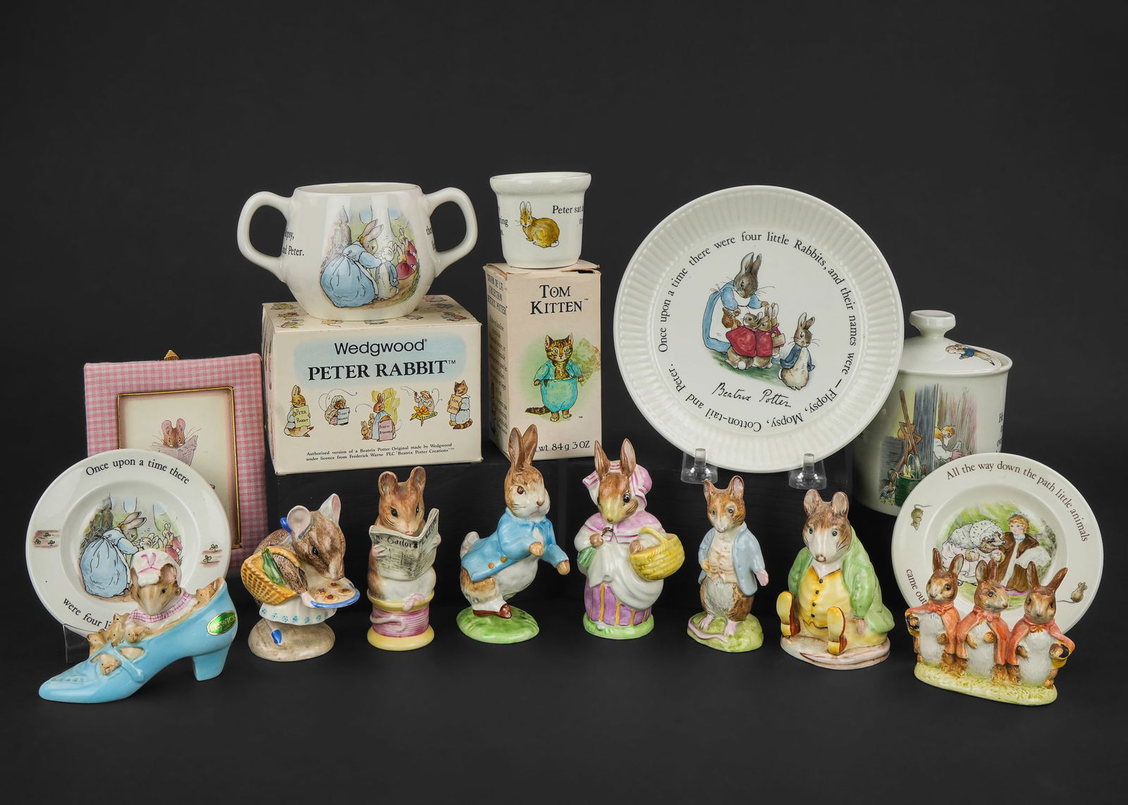 Beswick and Wedgwood Beatrix Potter Potter Items: Group of Beatrix Potter collectibles including 8 Beswick figurines, Wedgwood cups, plates, and covered jar (rim chip), Tom Kitten Crabtree and Evelyn gift soap, and The Tailor of Gloucester framed pri