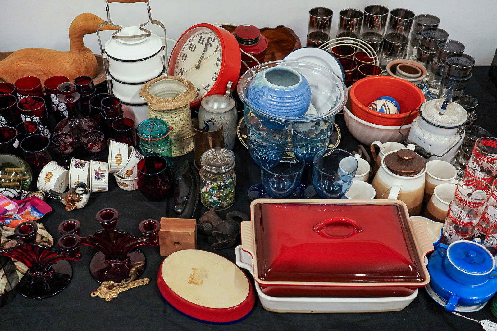 Large Group of Mid-Century Accessories: A large group of mid 20th c accessories including glassware, ruby glass, Pyrex, Emile Henry cookware, art pottery, and more.